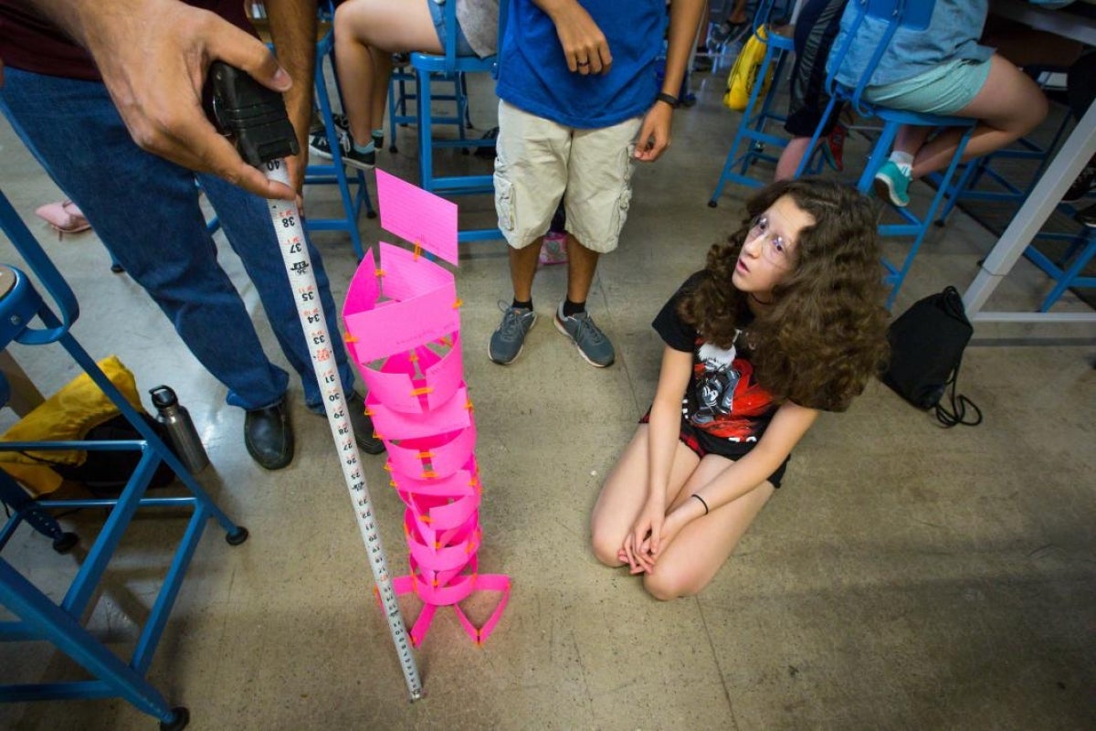 camp counselor measuring paper tower