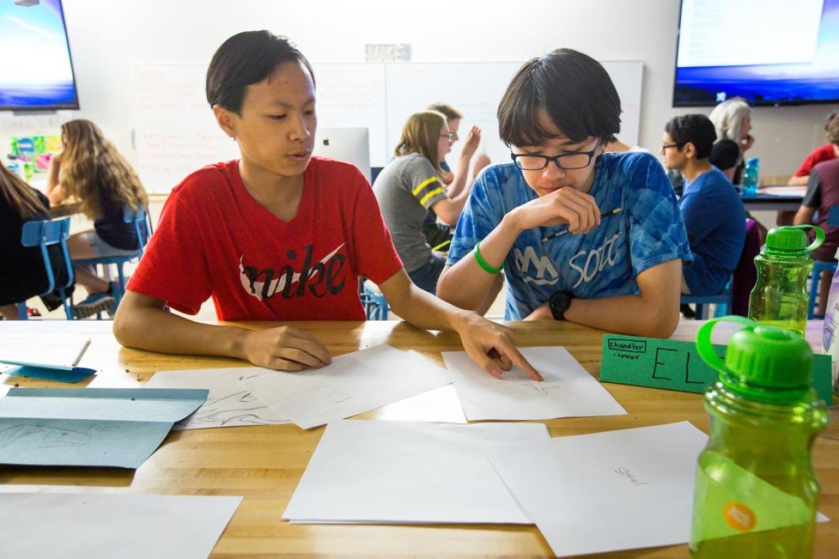 two students sketching designs for a prototype