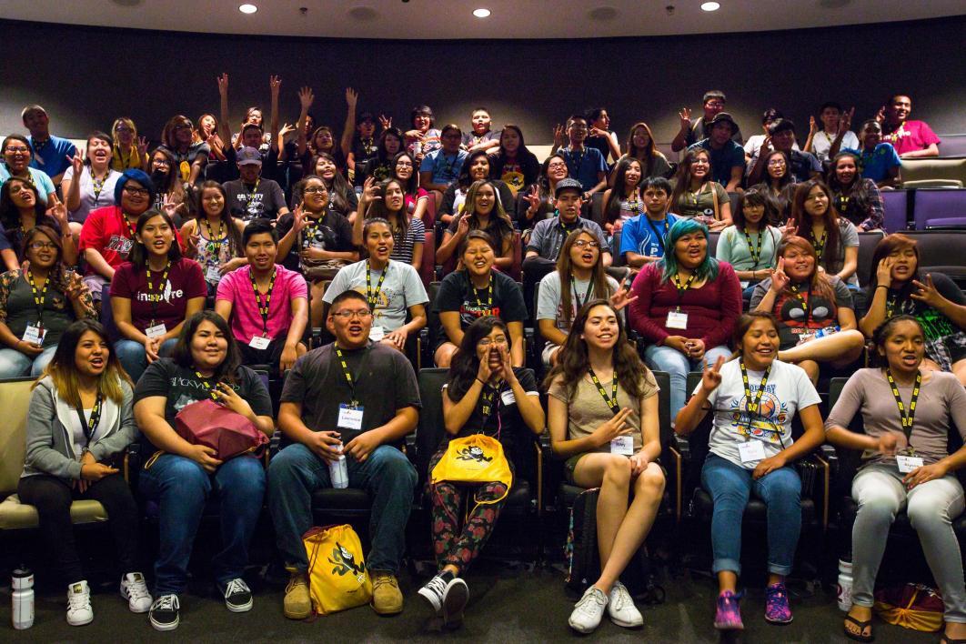 An audience of students cheers at Inspire camp.