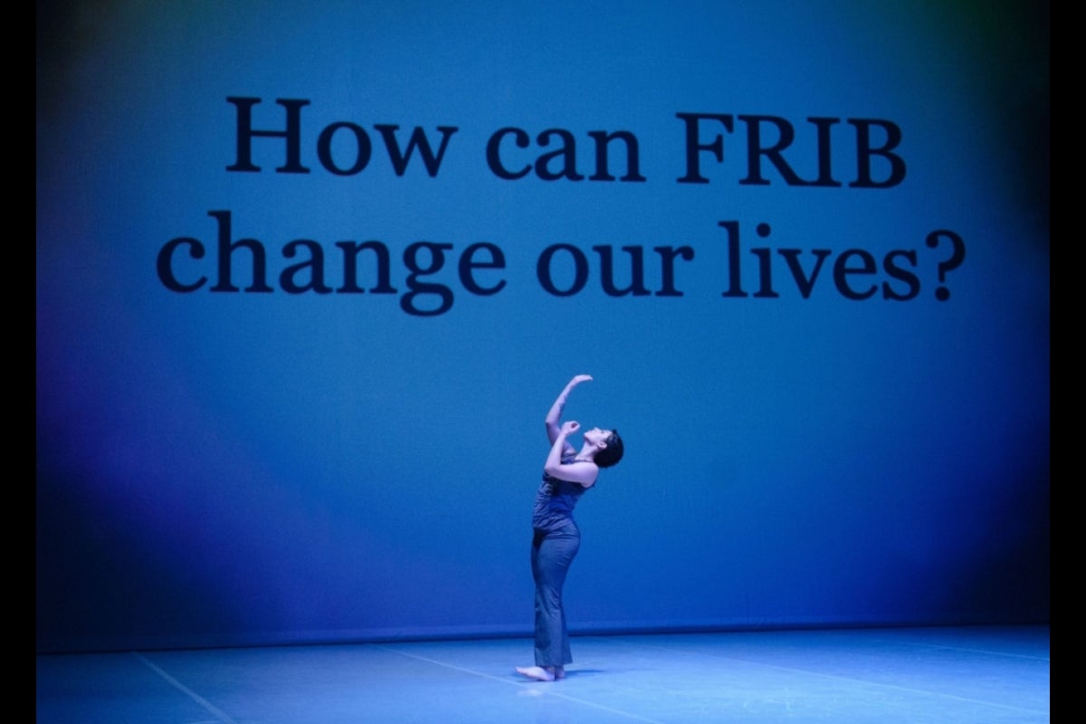 Dancer standing on a stage with the words 