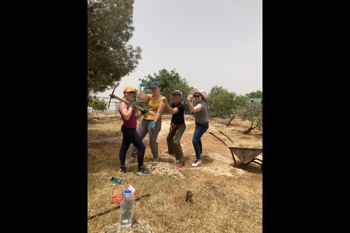 People posing at outdoor volunteer site in Israel