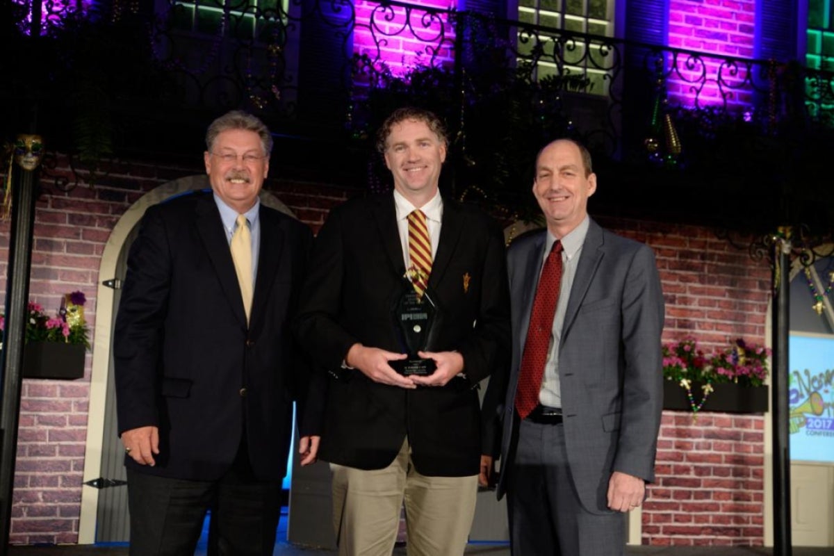 man holding award