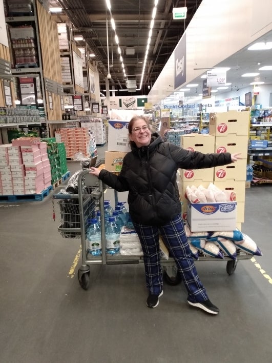 Jessica Hirshorn poses with the supplies she and fellow volunteers are purchasing to support Ukrainian refugees.