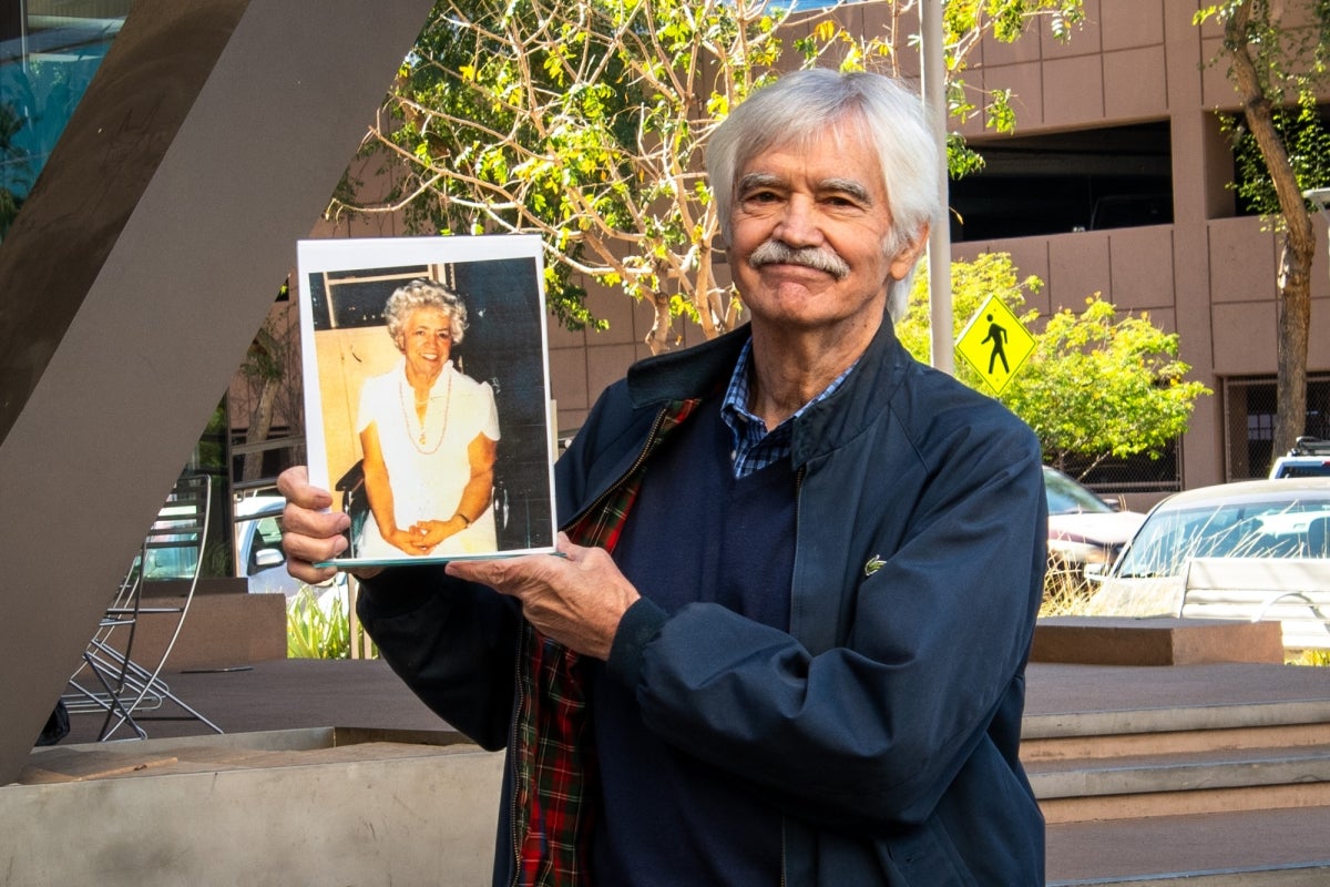 Photo of ASU Law alumnus Jim McAnally holding a photo of his mom, Virginia Miller.