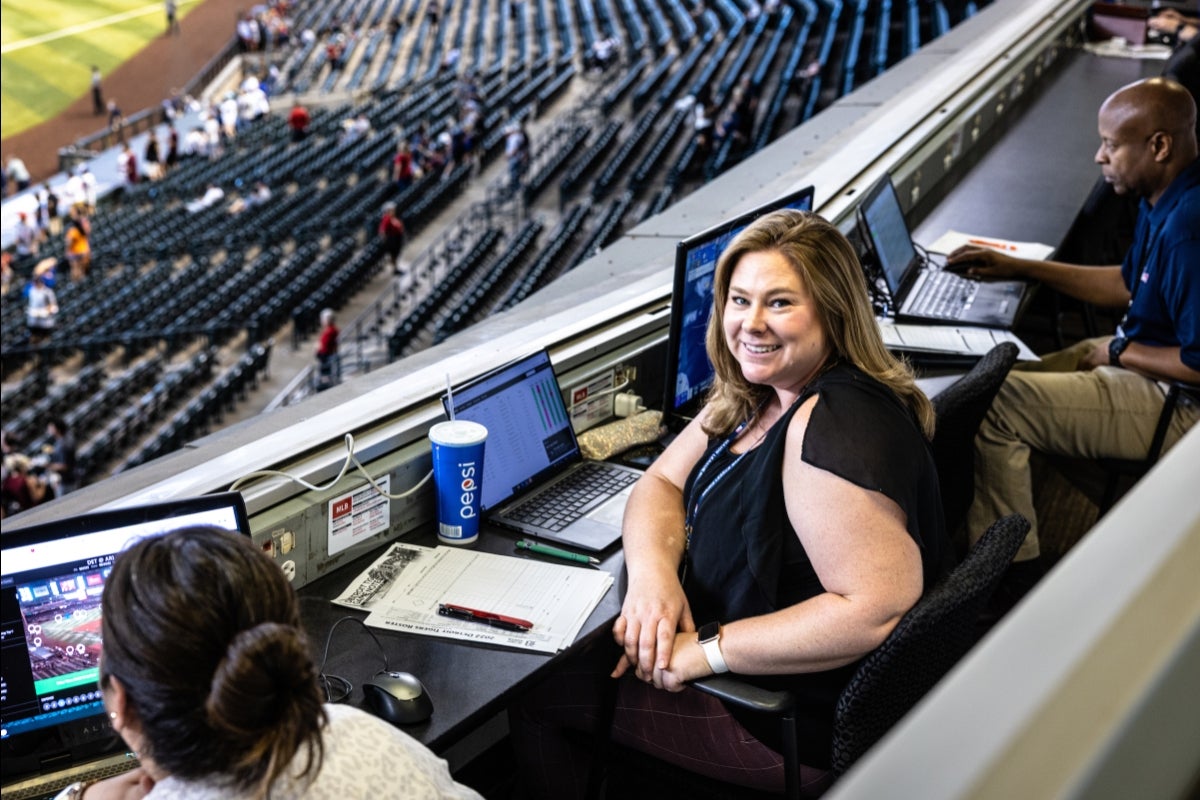 ASU alum Kara Blackstone seated in the stands of a baseball field.