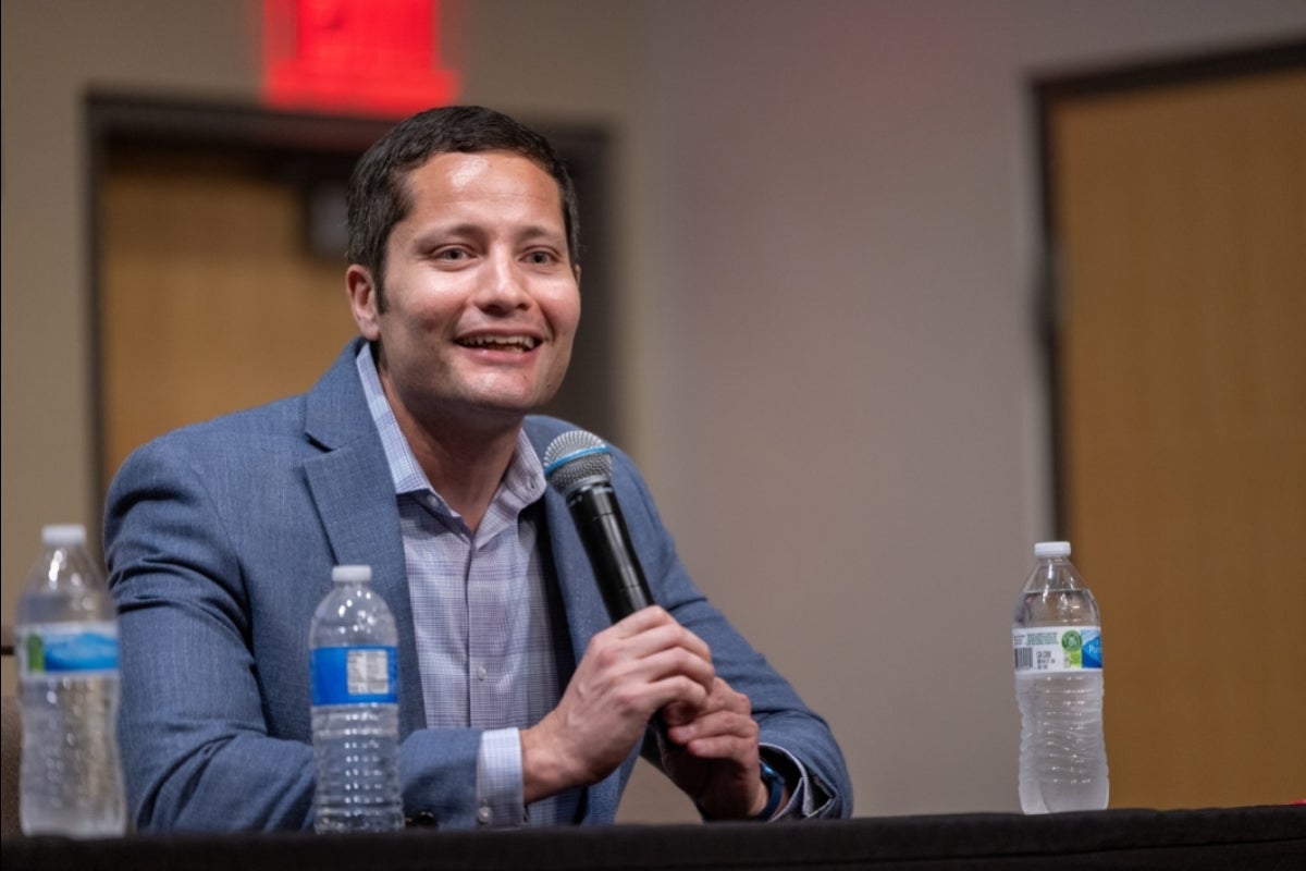 Man speaking into a microphone.