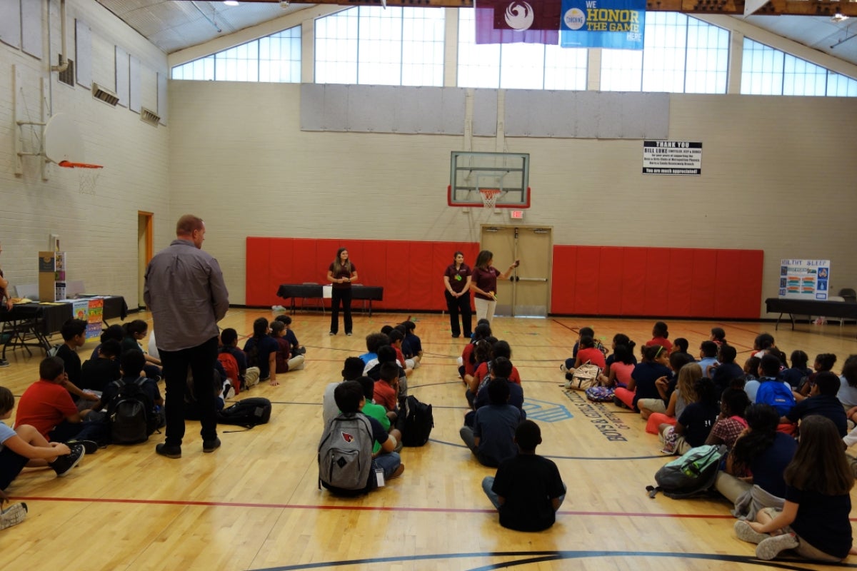 ASU nursing students explaining how the health fair will work at a Phoenix area Boys and Girls Club