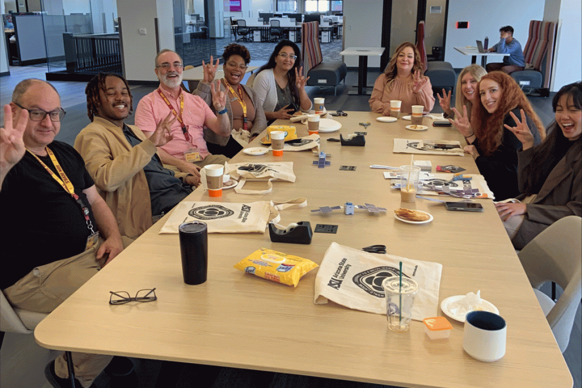 People sitting around a conference table smile