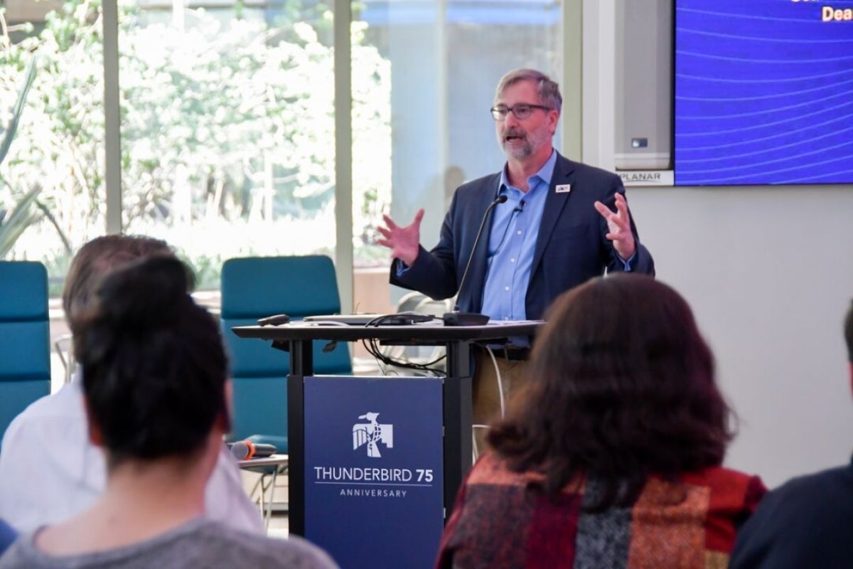 David Knower pictured at a podium giving a presentation.