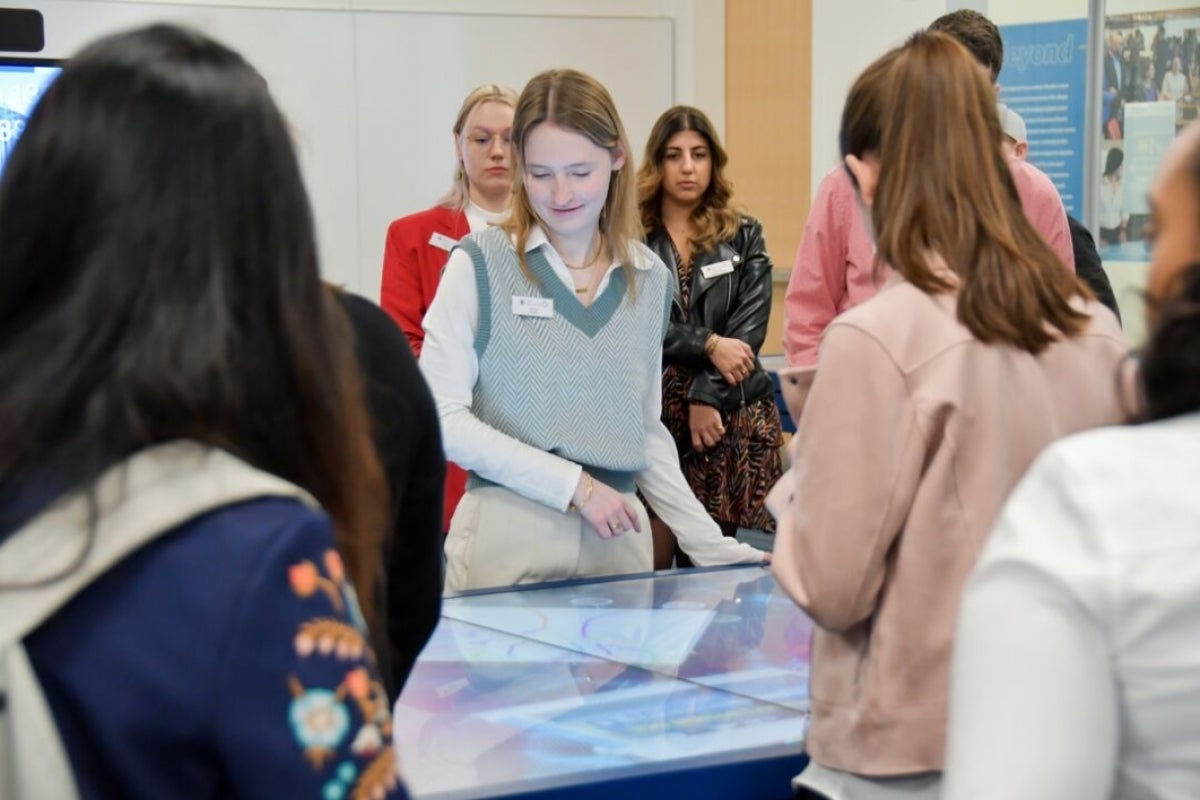 Attendees shown looking at the collaboration tables.