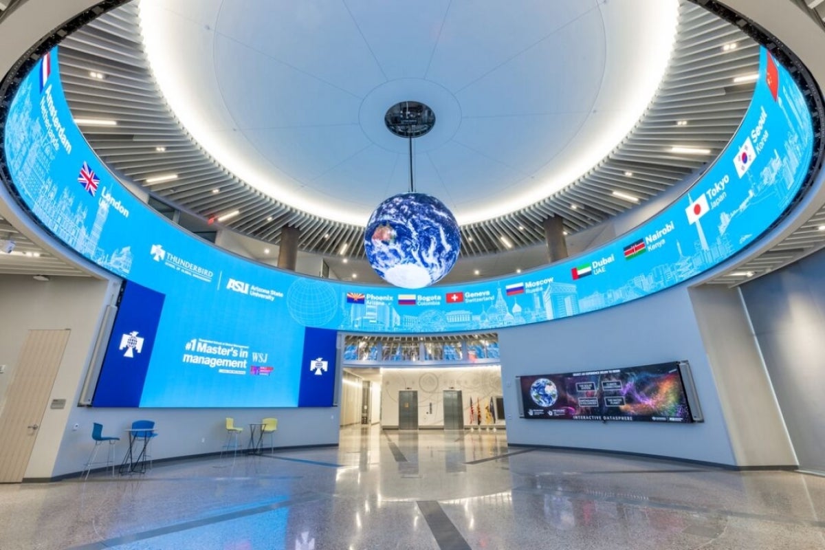 View looking up toward a globe hanging from the ceiling in a circular room.