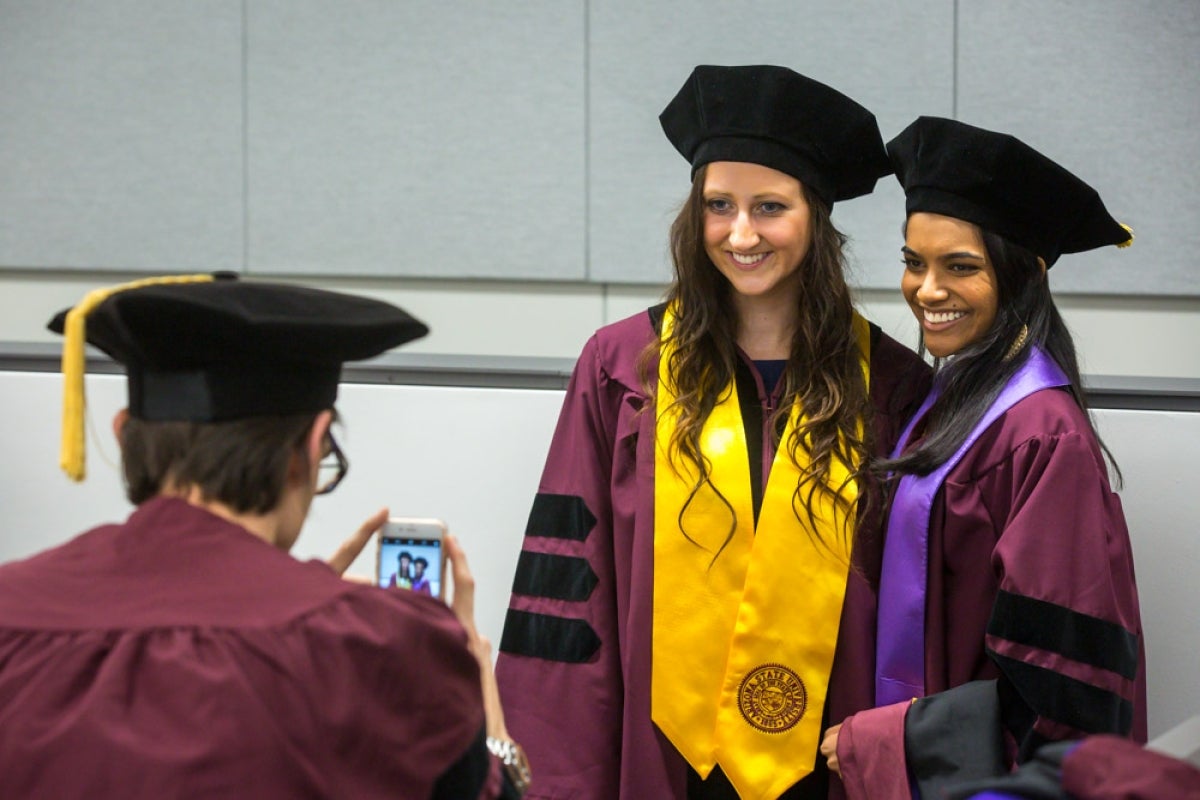 Taking a picture of two grads