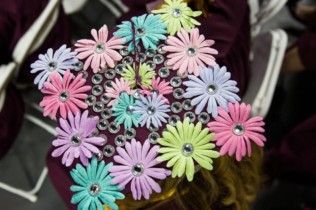 A graduation cap covered in pastel flowers