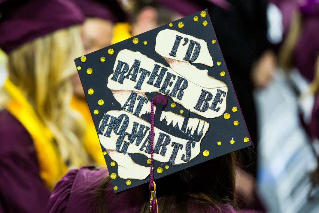 A graduation cap says, 