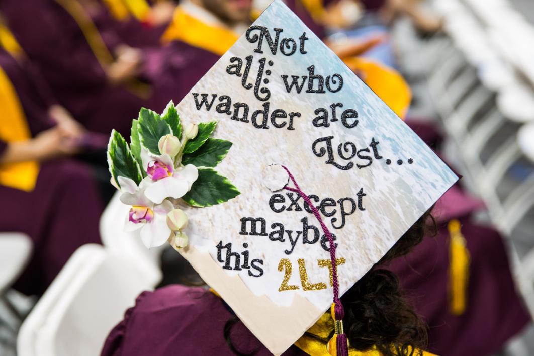 A graduation cap says, 