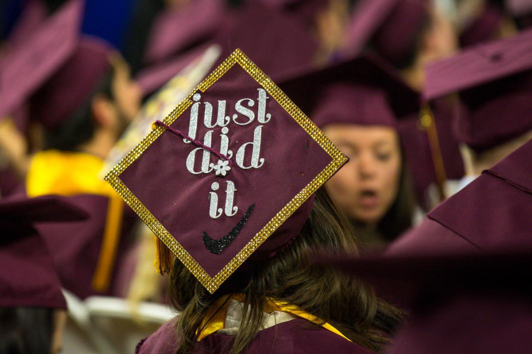 A graduation cap says, 