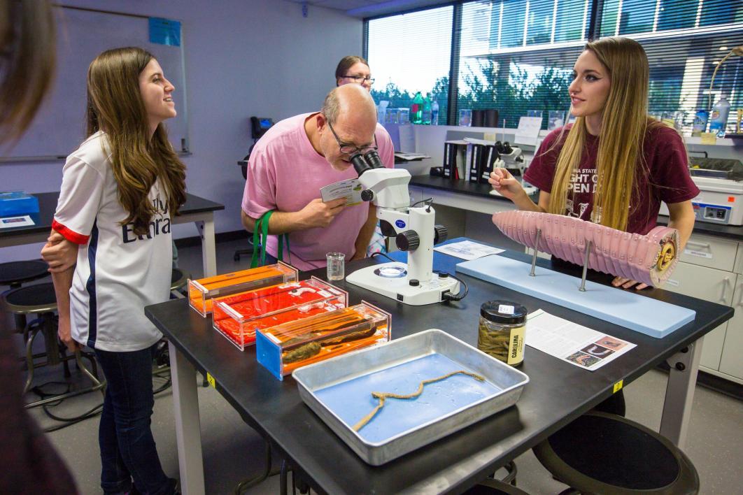 People use a microscope in a biology lab.