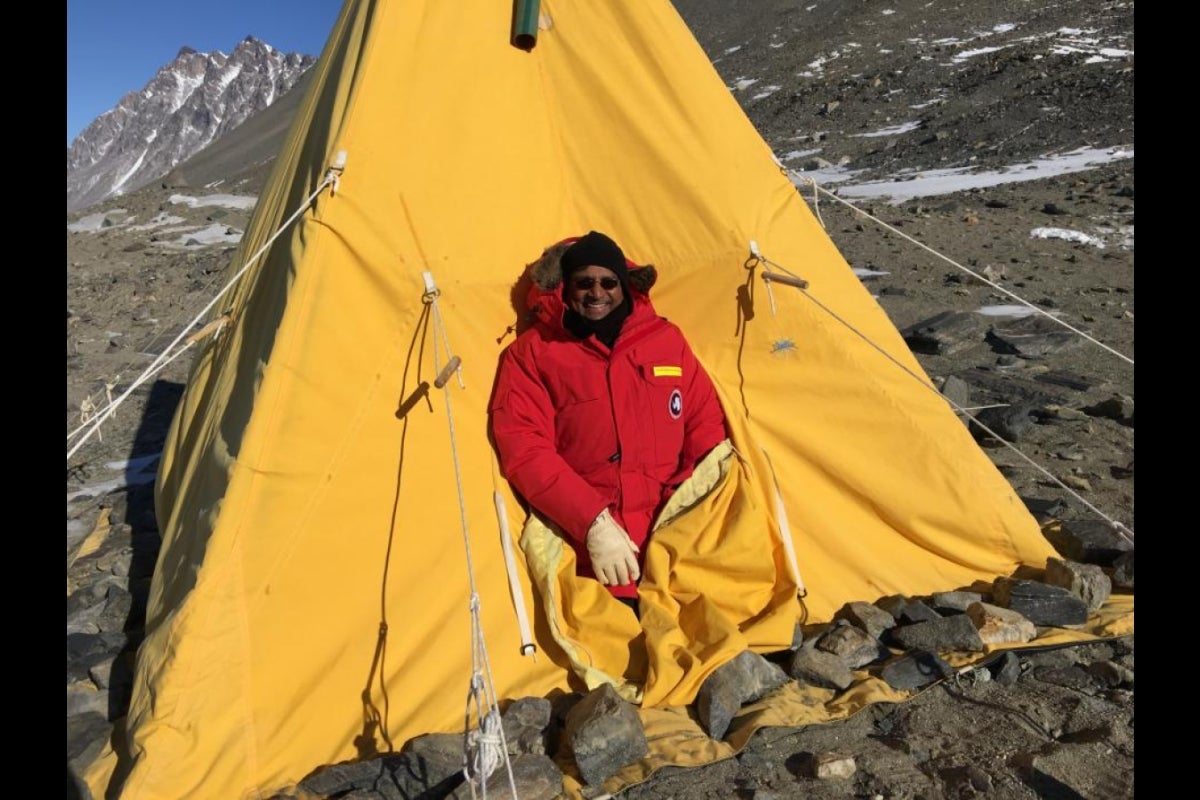 man looking out from tent in Antarctica