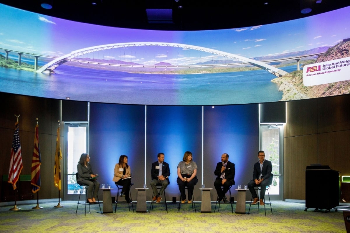 Panelists speak at the Arizona Water Innovation Initiative launch, sitting in chairs lined up.