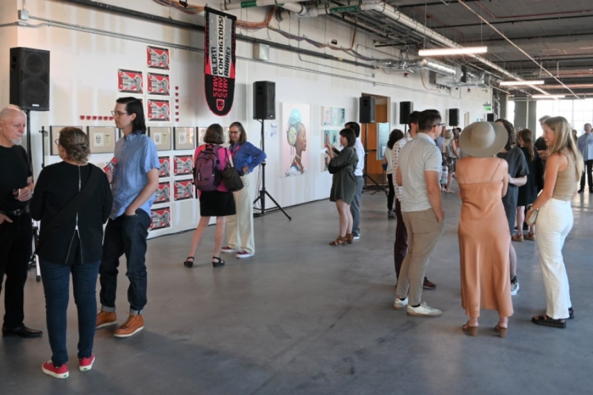 People milling about at an art exhibition.