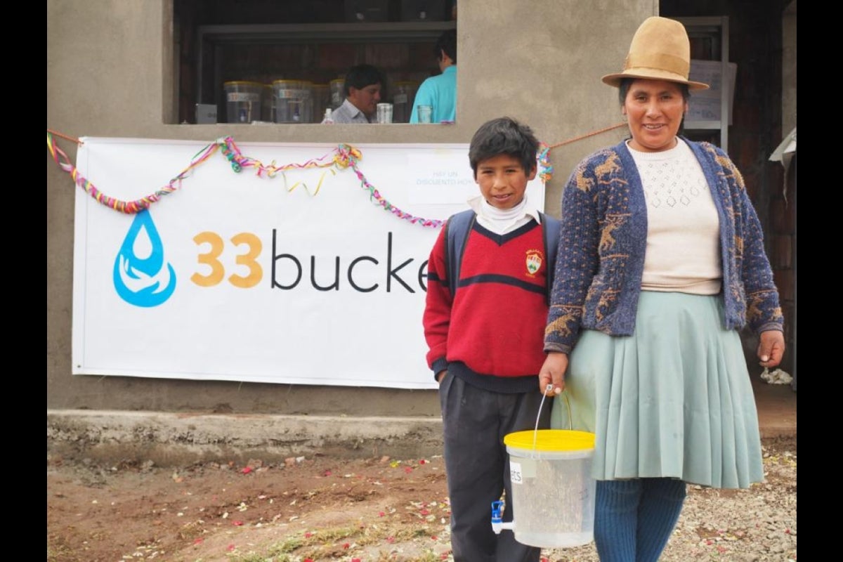 Huillcapata residents purchase the first container of filtered water from Agripino's business.