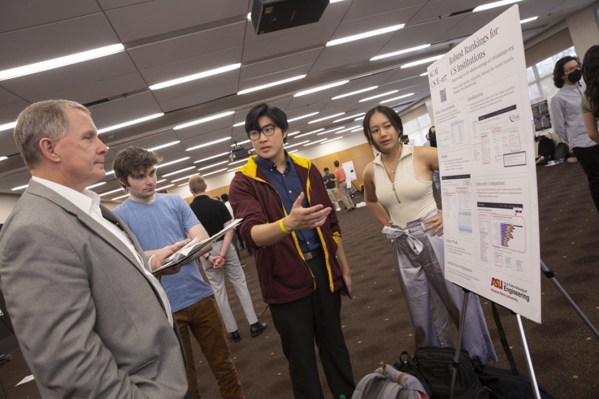 Students present their poster to an industry sponsor