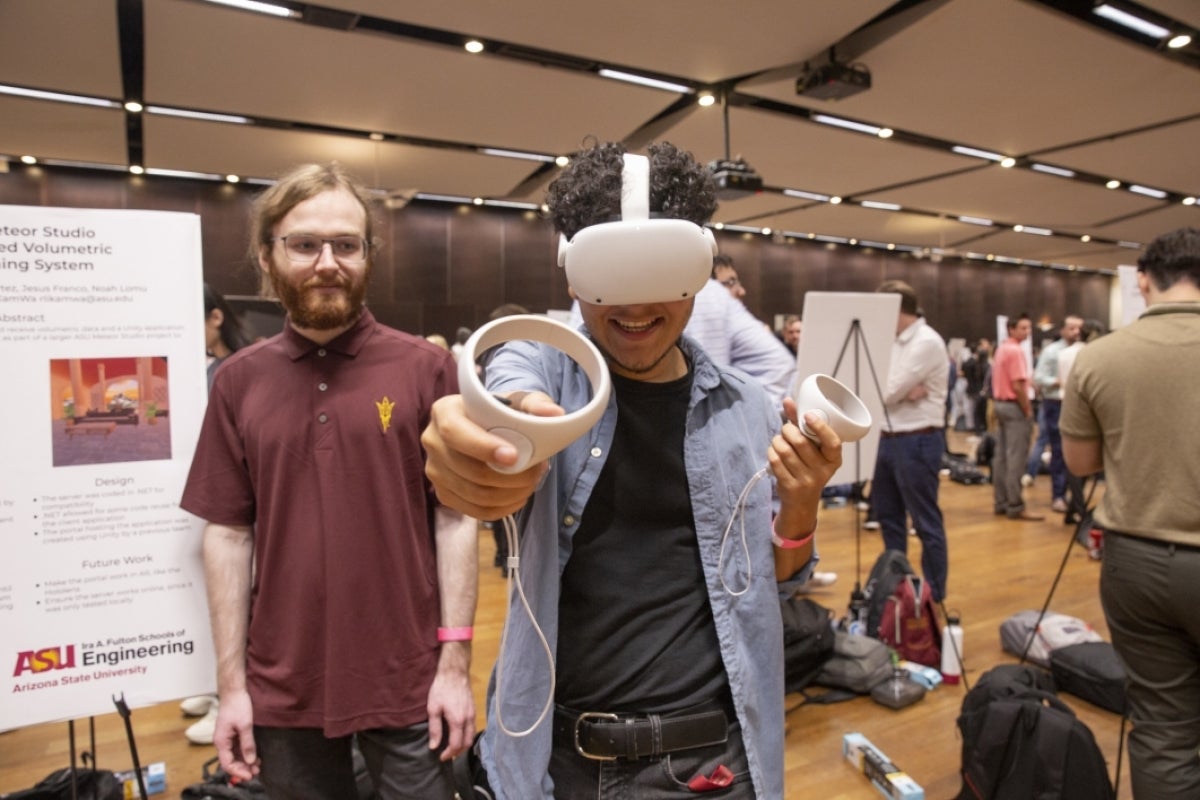 A student demonstrates how to use a virtual reality headset