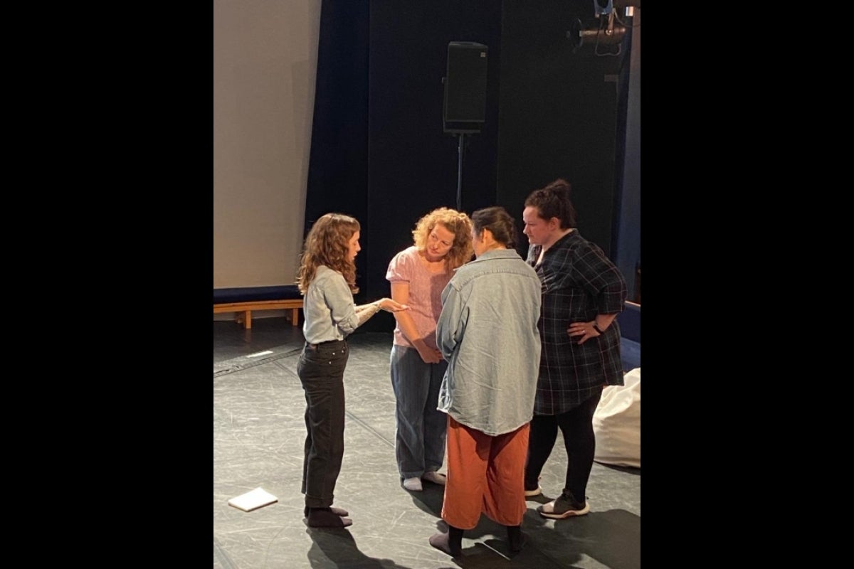 Group standing in a circle mid-discussion.