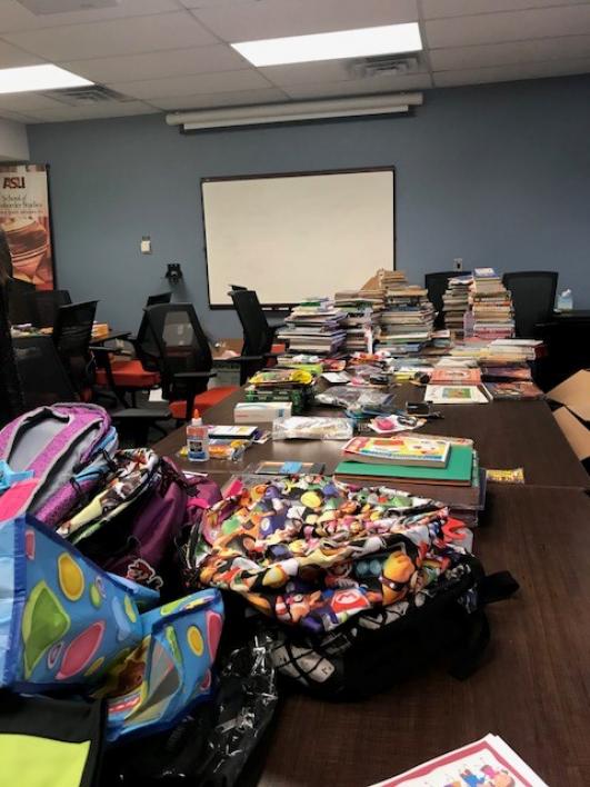 tables full of school supplies in a classroom