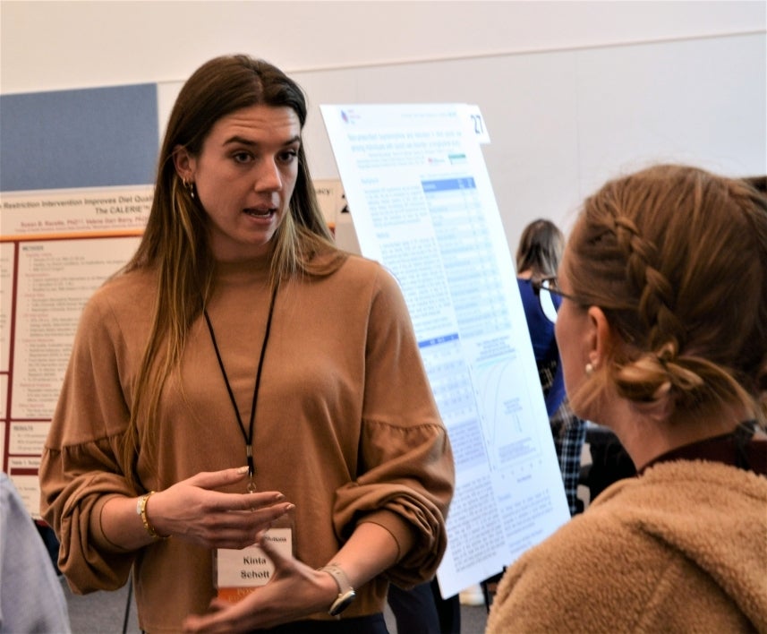 College of Health Solutions Faculty Research Day attendees conversing.