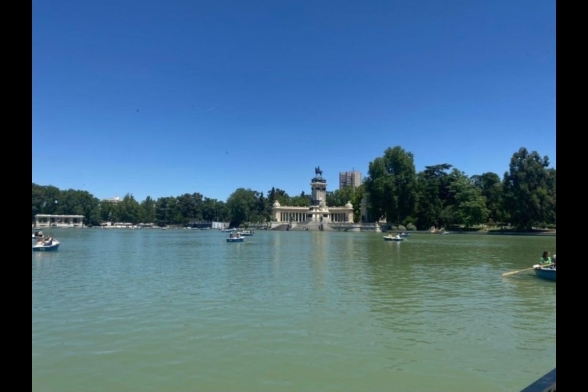 Row boats on a lake with a stone structre in it.