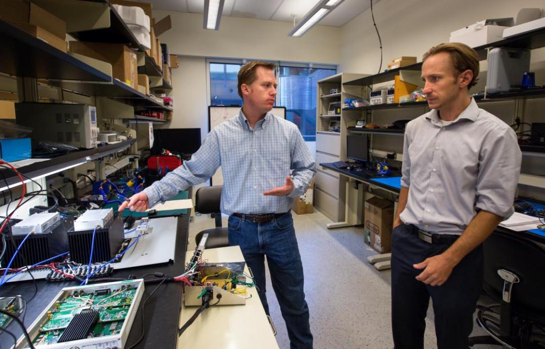 two men talking in lab