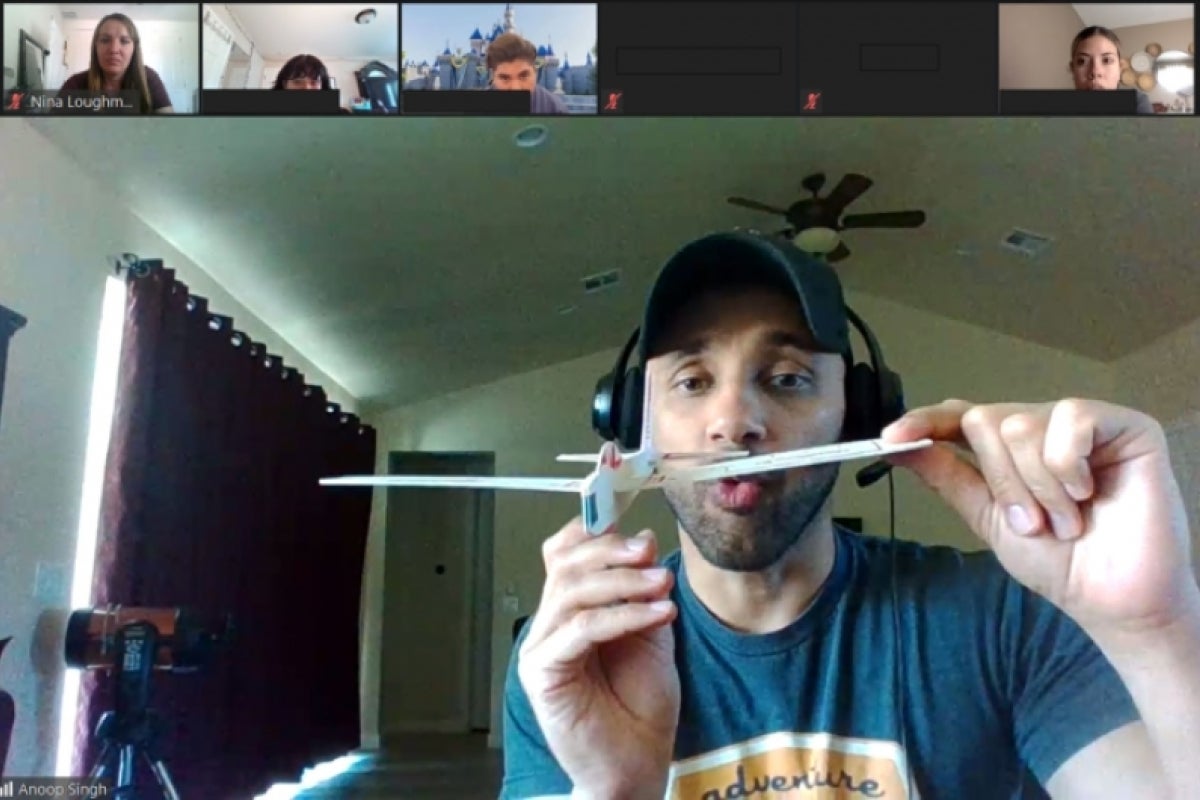 A Zoom screenshot in which Lecturer Anoop Singh holds a balsa wood aircraft and talks to SEE@ASU participants about aerodynamics.