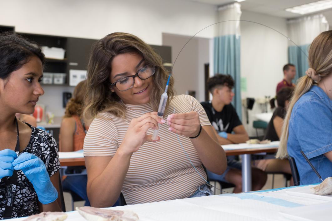 student holding syringe