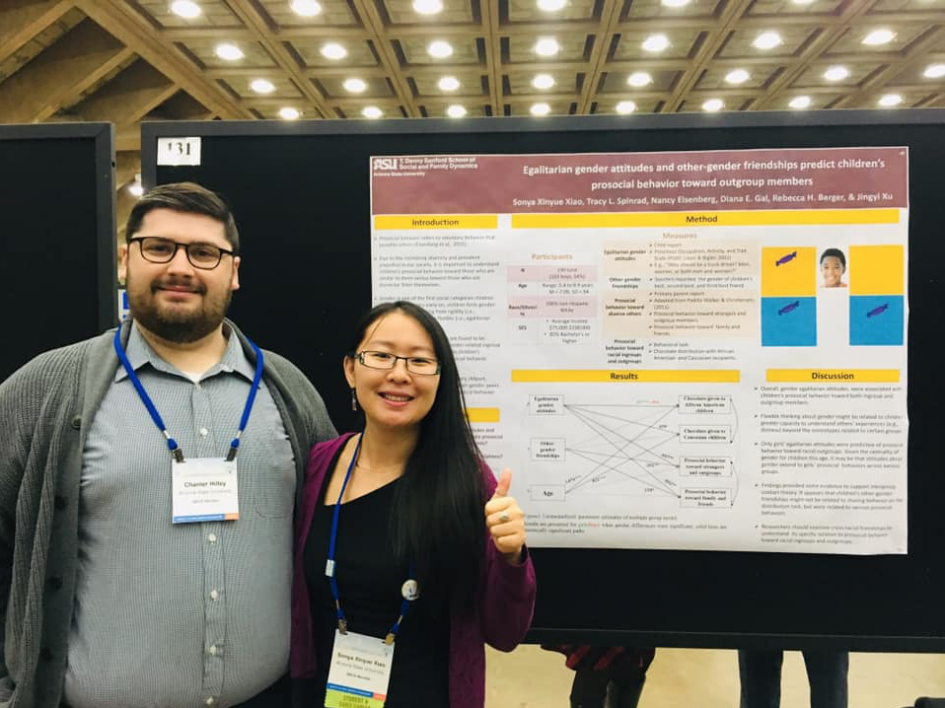 Sonya with a fellow grad student in front of her poster presentation.