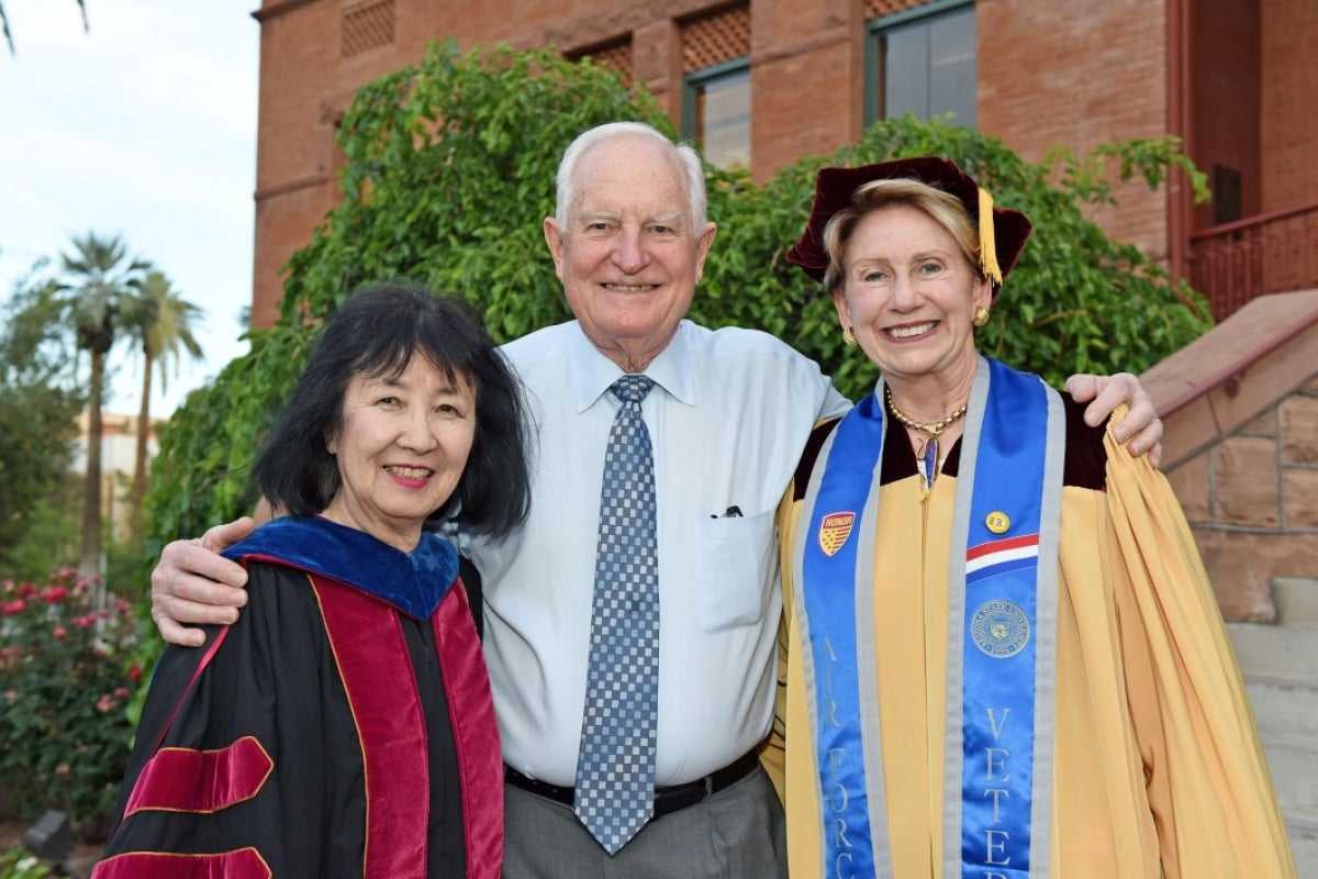 Three people pose for a photo