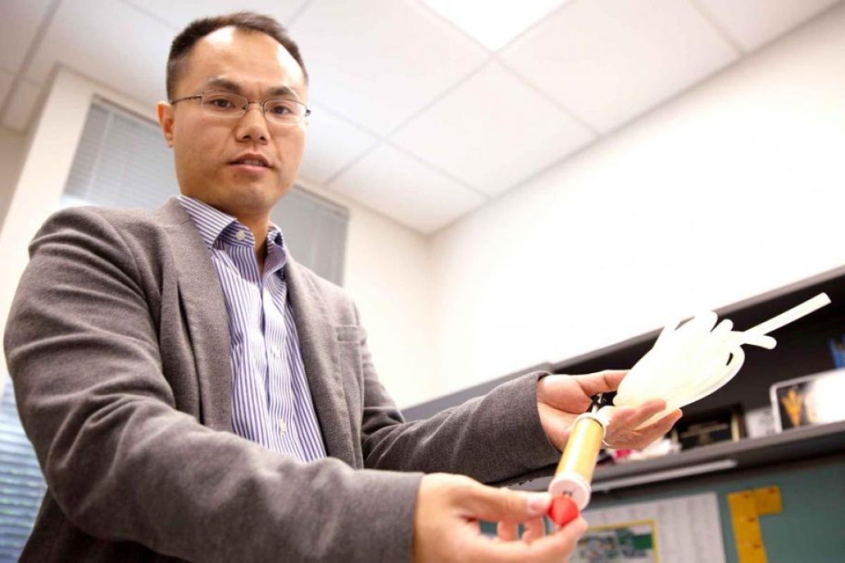 Junliang Tao holds burrowing device