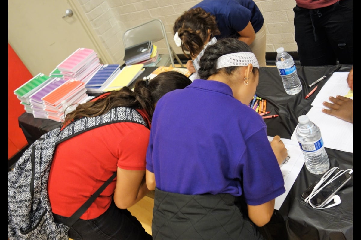 Health fair participants draw and journal as part of the stress management lesson