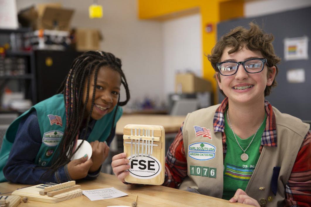 Two girls show a kalimba thumb piano