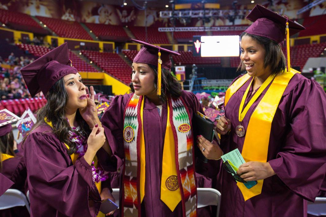 graduate wiping smudge off face of friend