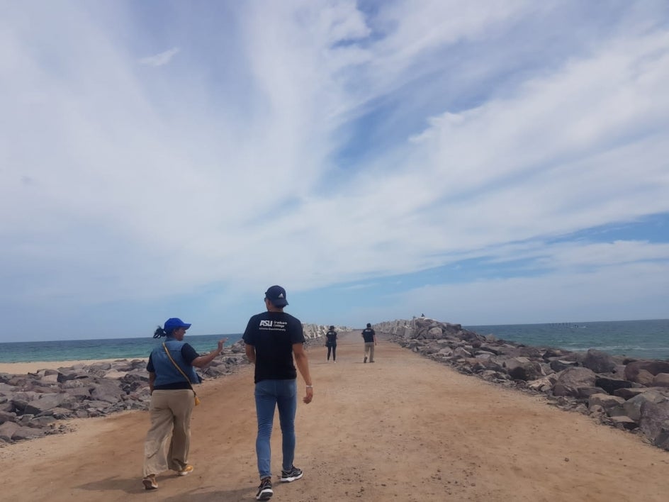 TEAM students and faculty walking on coastal pier