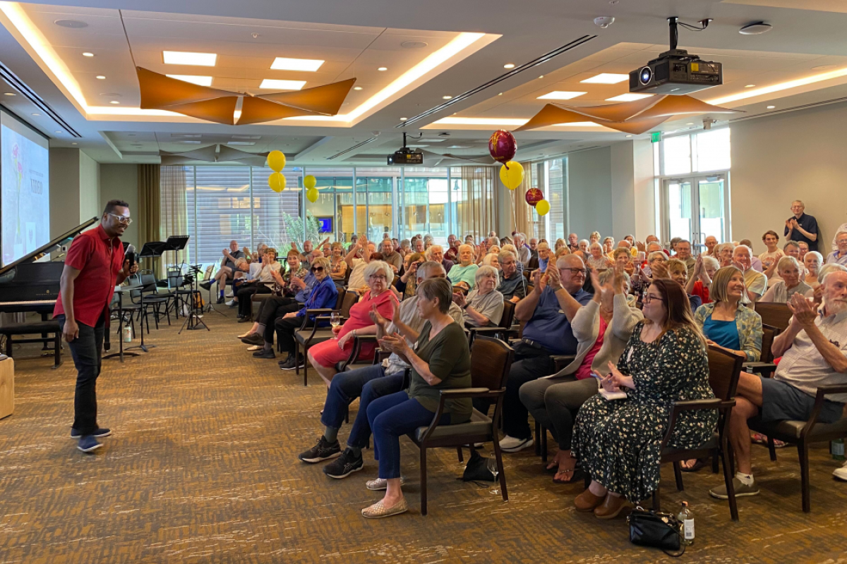 A group of Mirabella at ASU residents sitting in a room with a person standing in front.