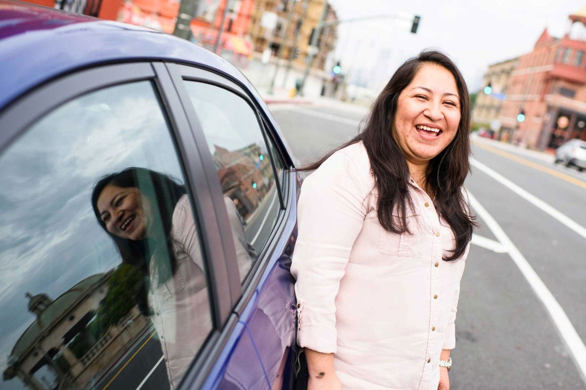 woman standing next to car