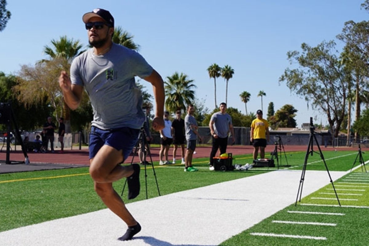 Man running on a football field.