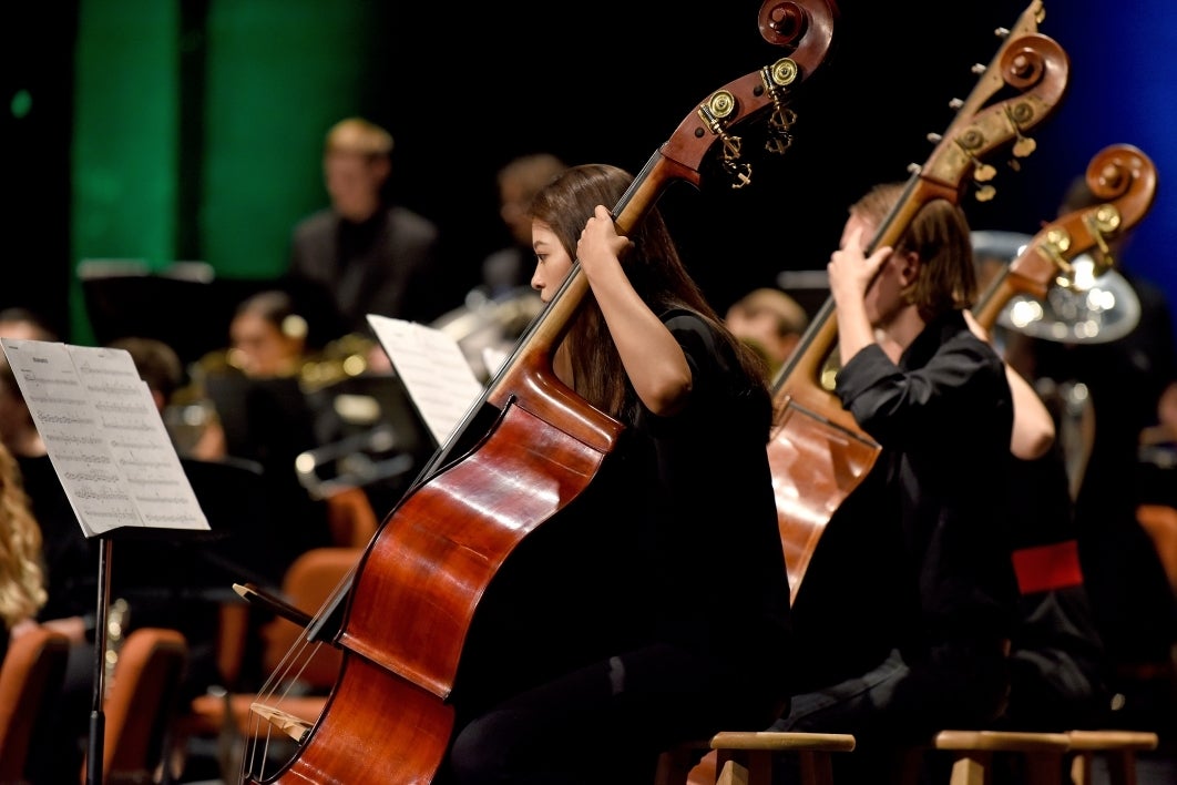 People onstage playing instruments.