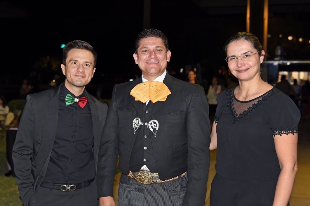 Three people smiling at the camera.