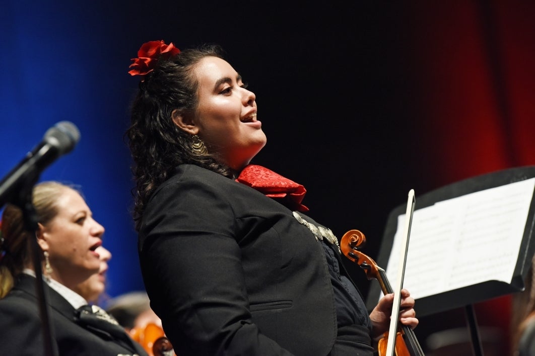 Woman singing onstage.