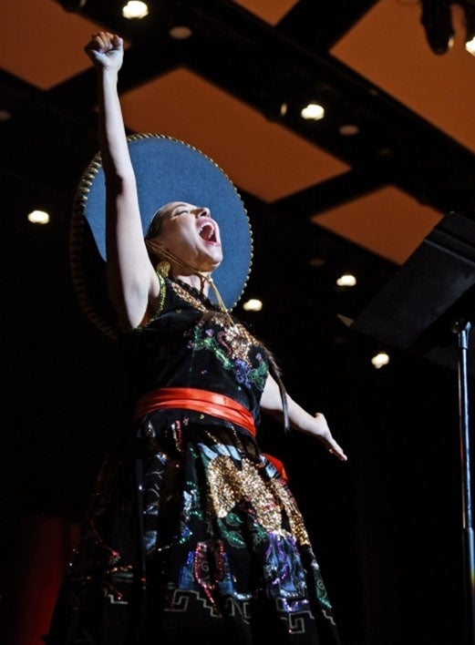 Woman singing onstage.