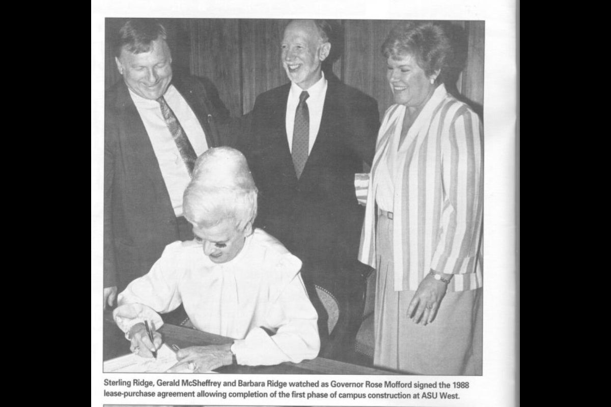 woman signing bill