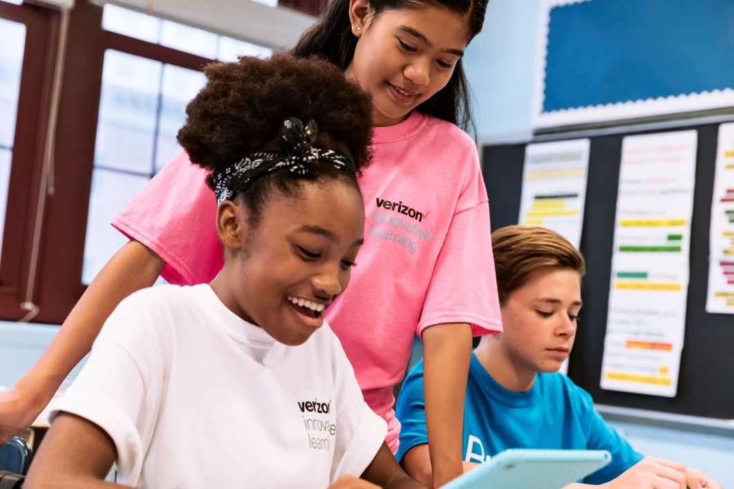 A group of youth learn about technology and design thinking